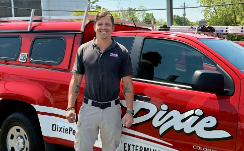 Technician inspecting home exterior entry points